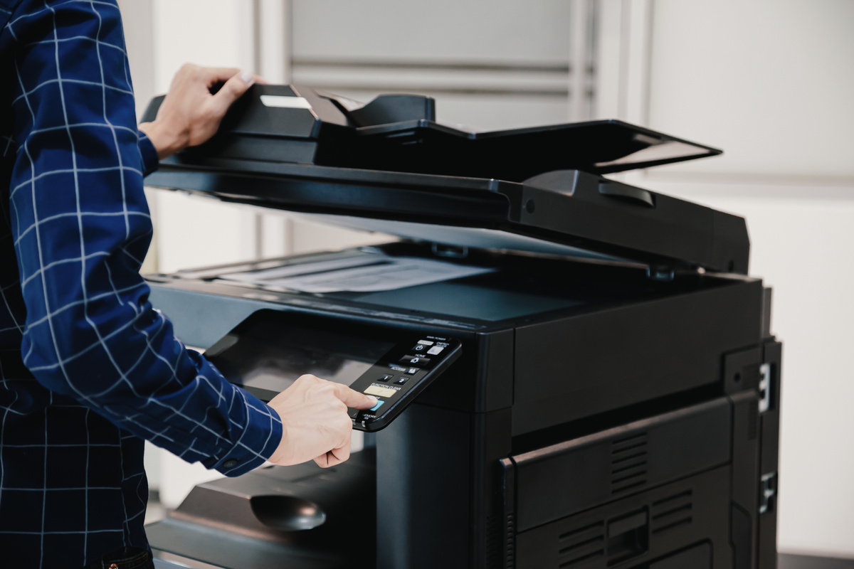 Copier printer, Close up hand office man press copy button on panel to using the copier or photocopier machine for scanning document printing a sheet paper.