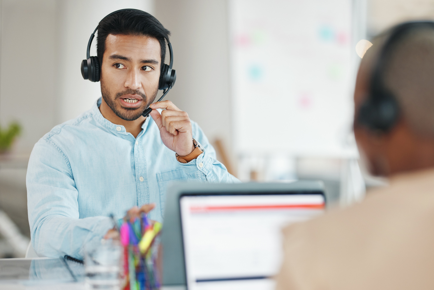 Customer support, office headset and man talking on telemarketing communication, contact us CRM or ERP telecom. Male ecommerce consultant, call center service or tech support consulting on microphone